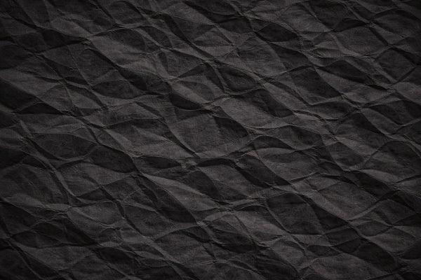 Crumpled black paper texture background for digital design projects